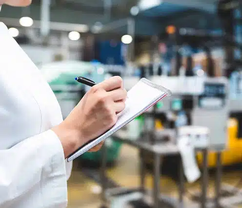 Quality assurance engineer inspecting RF manufacturing processes for compliance standards